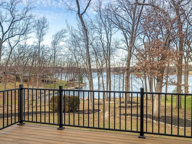 deck with a yard and a water view