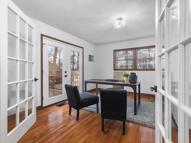 dining space featuring french doors and hardwood / wood-style flooring