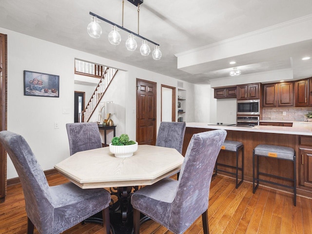 dining room featuring dark hardwood / wood-style flooring and ornamental molding