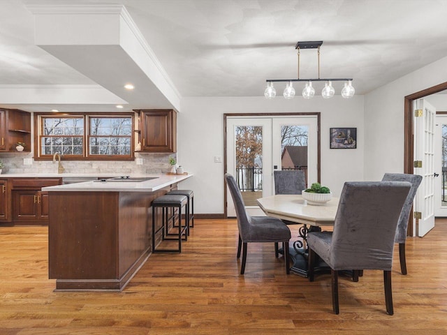 dining area with hardwood / wood-style floors, french doors, and ornamental molding