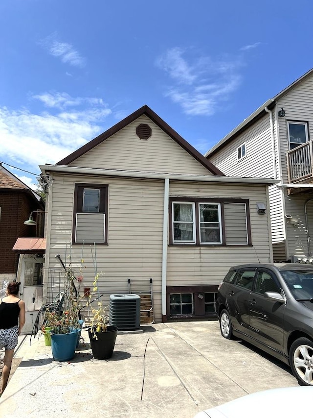 rear view of house with a patio area and central air condition unit