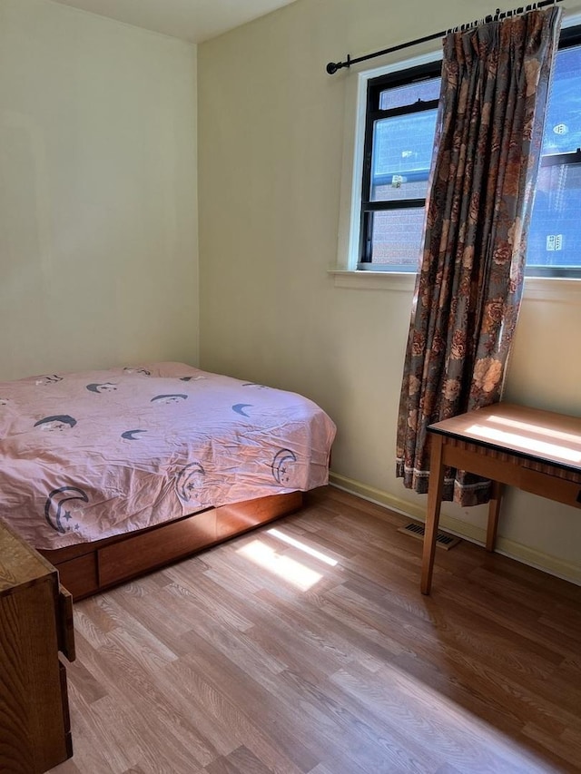 unfurnished bedroom with light wood-type flooring