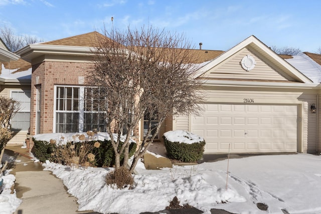 view of snowy exterior with a garage