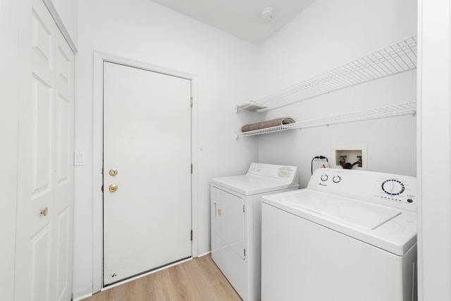 washroom featuring light hardwood / wood-style floors and washer and clothes dryer