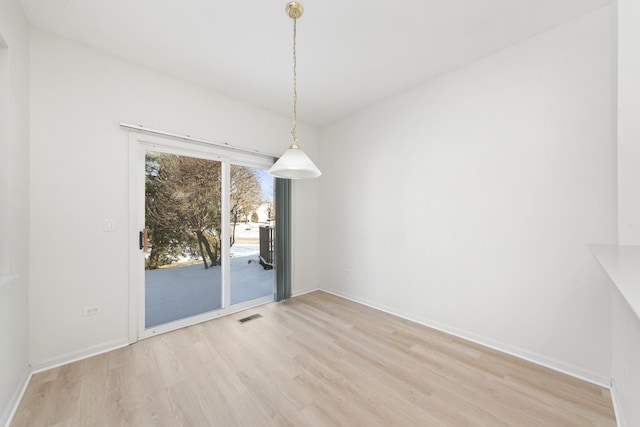 unfurnished dining area featuring light hardwood / wood-style flooring