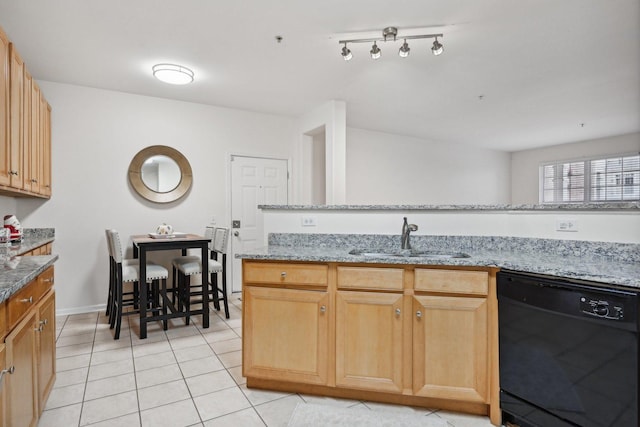 kitchen featuring light stone countertops, black dishwasher, light tile patterned flooring, and sink