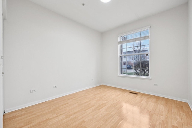 unfurnished room with light hardwood / wood-style floors