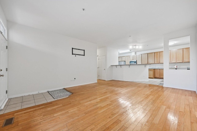 unfurnished living room featuring light hardwood / wood-style flooring