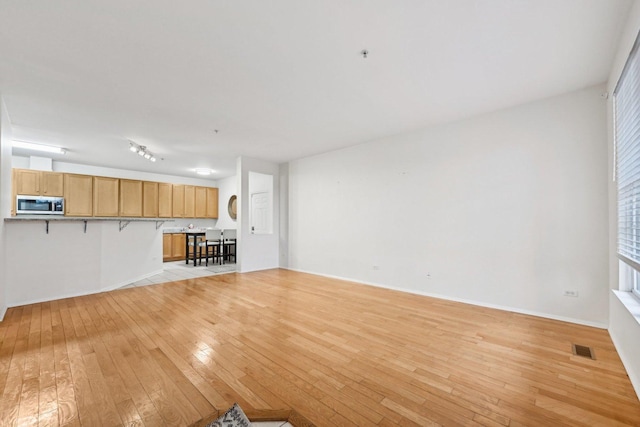 unfurnished living room with light hardwood / wood-style flooring