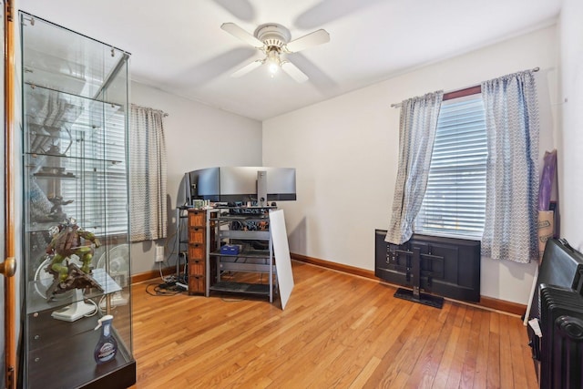 office with hardwood / wood-style flooring and ceiling fan