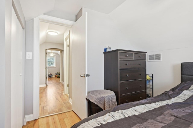 bedroom featuring light hardwood / wood-style flooring and lofted ceiling