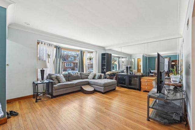 living room with ornamental molding and wood-type flooring