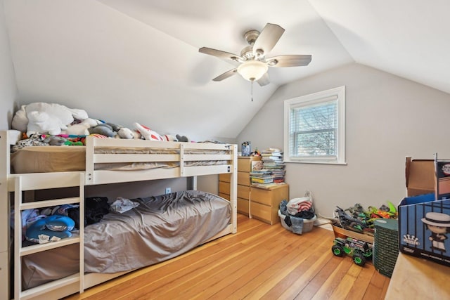 bedroom featuring ceiling fan, wood-type flooring, and vaulted ceiling