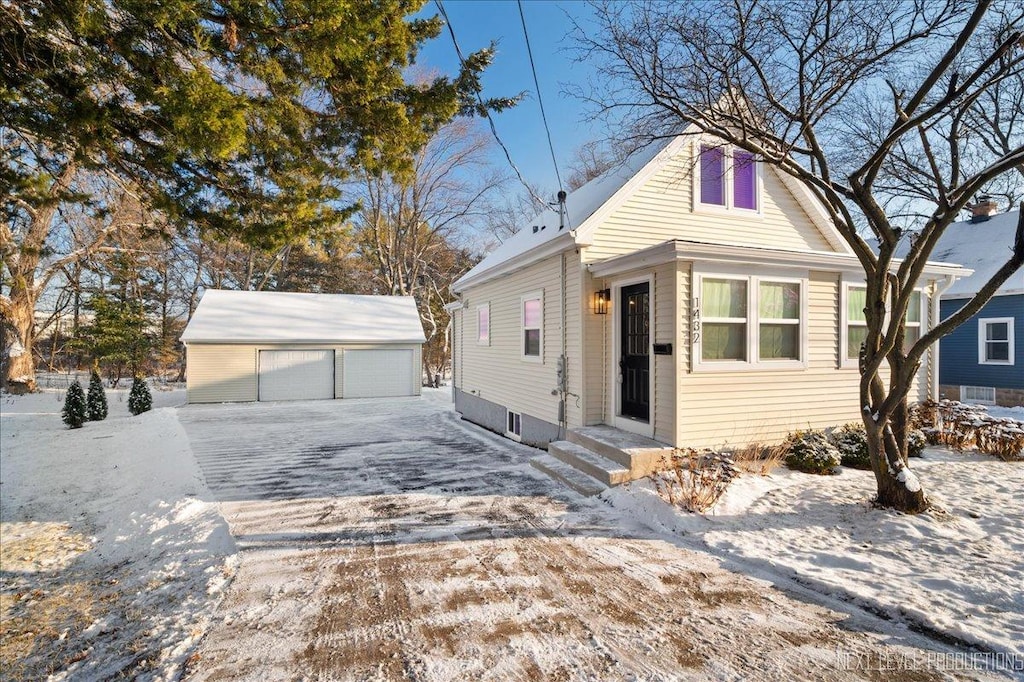 view of front of home featuring a garage and an outdoor structure