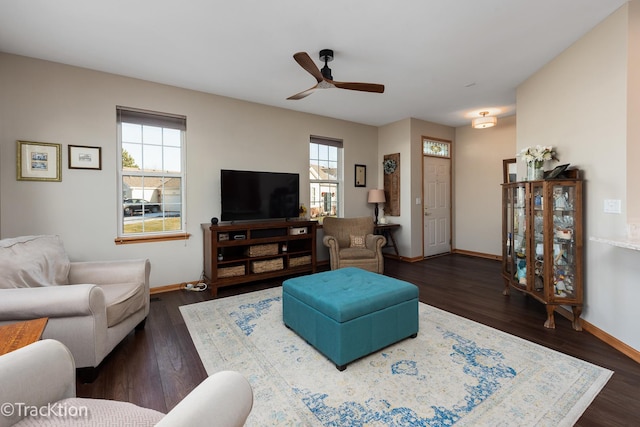 living room with ceiling fan, dark wood-type flooring, and a wealth of natural light