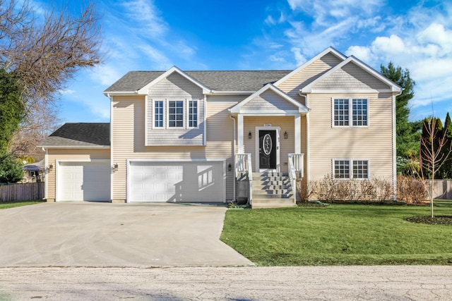 bi-level home with a garage and a front yard