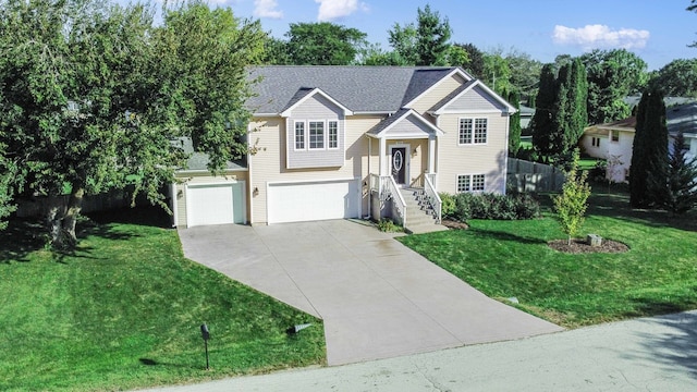 split foyer home with a garage and a front lawn