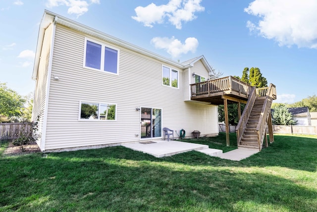 back of house with a patio area, a wooden deck, and a yard