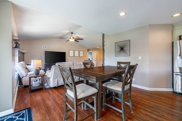 dining room with ceiling fan, dark wood-type flooring, and lofted ceiling