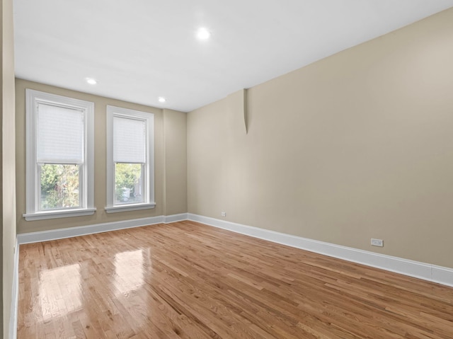 spare room with light wood-type flooring