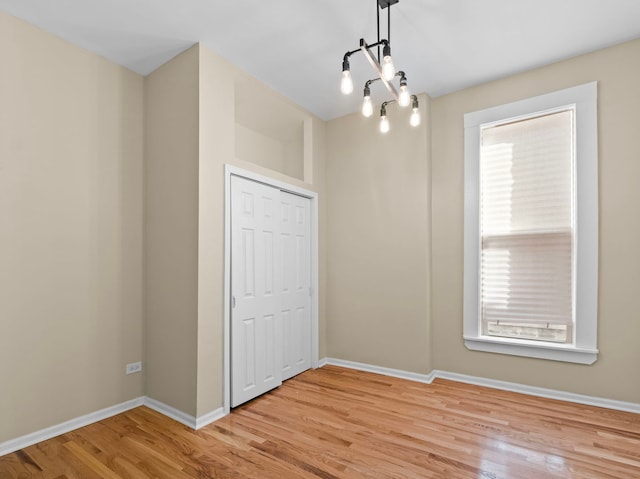 interior space featuring light hardwood / wood-style floors, a closet, and multiple windows