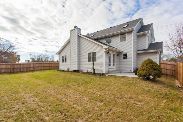 back of property featuring a yard and a patio