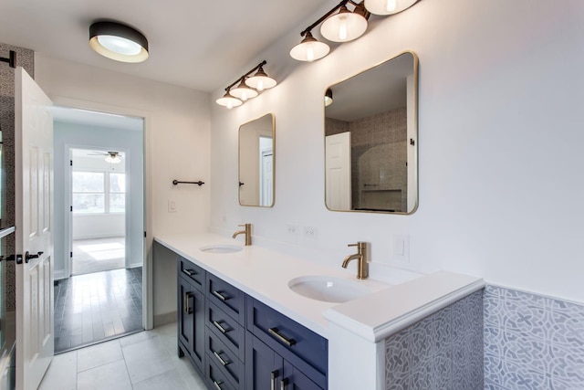 bathroom with ceiling fan, vanity, and tile patterned floors