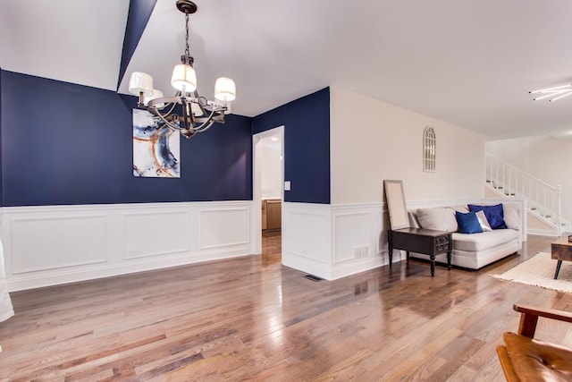 interior space featuring wood-type flooring and a chandelier