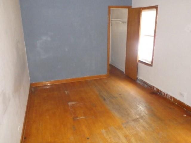 unfurnished room featuring hardwood / wood-style flooring and a wealth of natural light