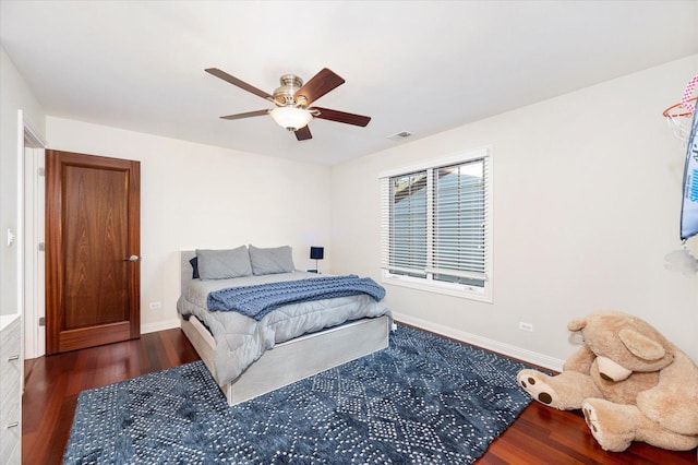 bedroom with ceiling fan and dark wood-type flooring