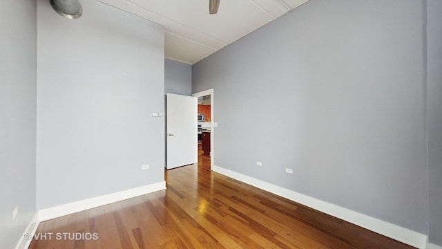 unfurnished room with ceiling fan and hardwood / wood-style floors