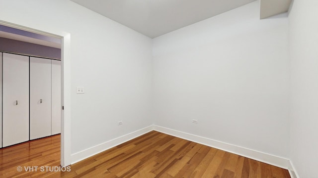 unfurnished bedroom with a closet and hardwood / wood-style floors