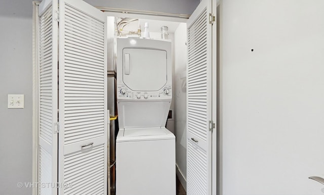 washroom featuring stacked washer and dryer