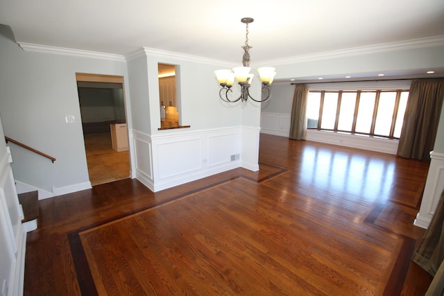 unfurnished dining area with a notable chandelier, ornamental molding, and dark hardwood / wood-style floors