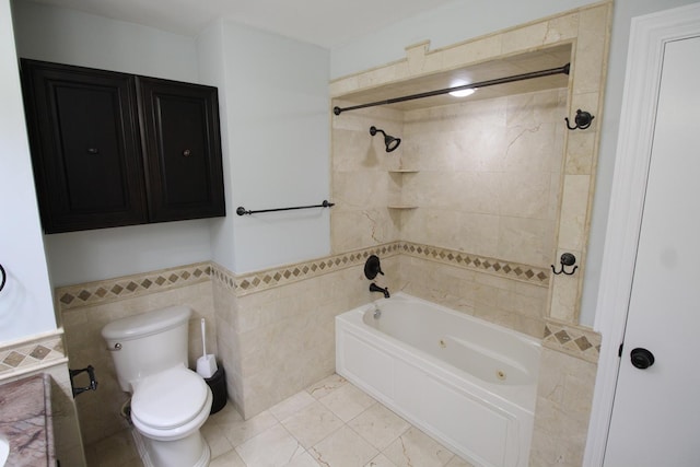 bathroom with tile walls, toilet, and tiled shower / bath