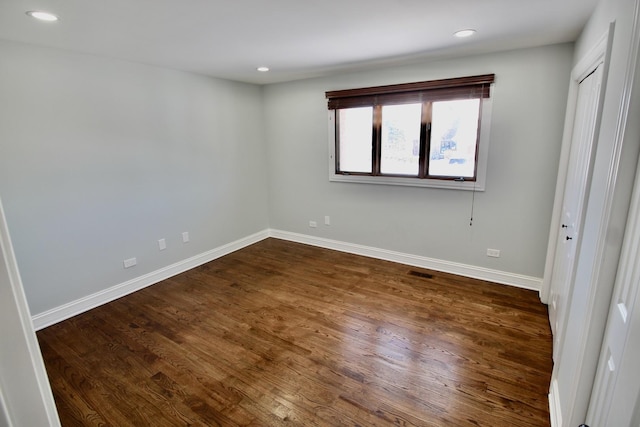 unfurnished bedroom with dark wood-type flooring