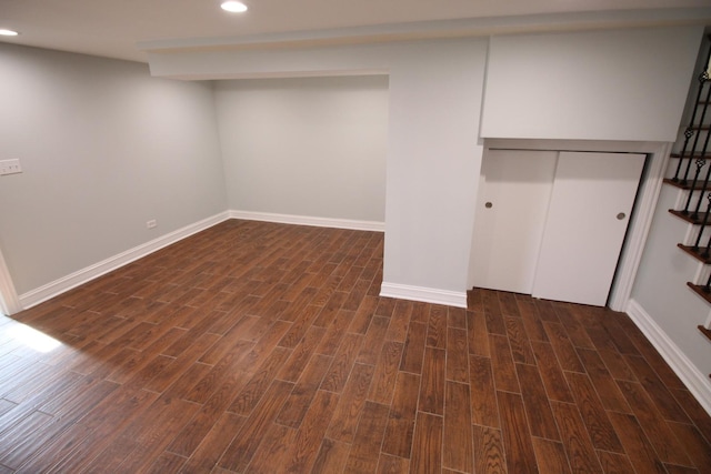 basement with dark hardwood / wood-style floors