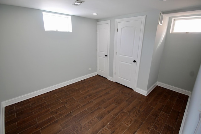 basement with dark hardwood / wood-style flooring