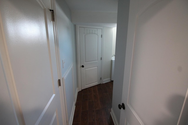 corridor with dark hardwood / wood-style flooring