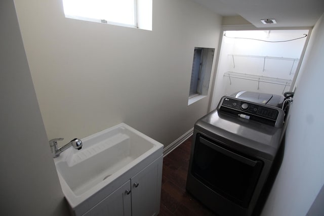 washroom featuring washer / dryer, sink, and dark hardwood / wood-style flooring