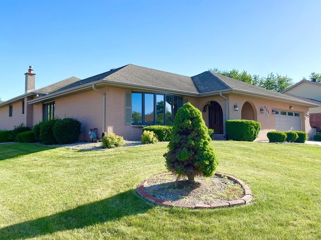 single story home featuring a garage and a front lawn