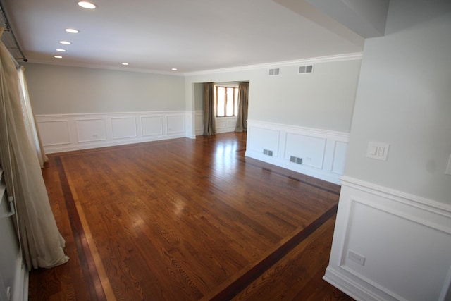 empty room with crown molding and dark hardwood / wood-style floors