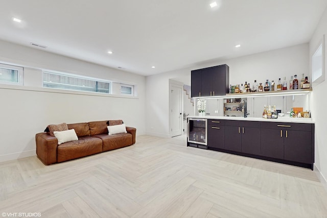 living room with indoor bar, wine cooler, and light parquet flooring