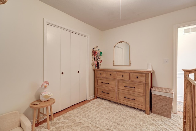 bedroom featuring light wood-type flooring and a closet