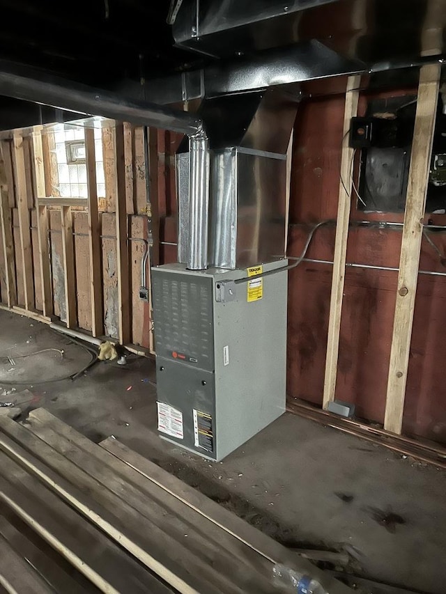 utility room featuring heating unit