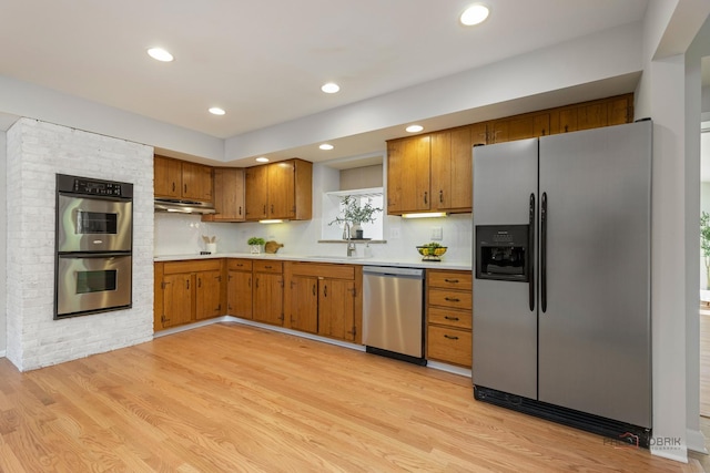 1712 Shawnee Trl, Northbrook, IL 60062 - kitchen featuring appliances with stainless steel finishes, brown cabinetry, light countertops, light wood finished floors, and recessed lighting