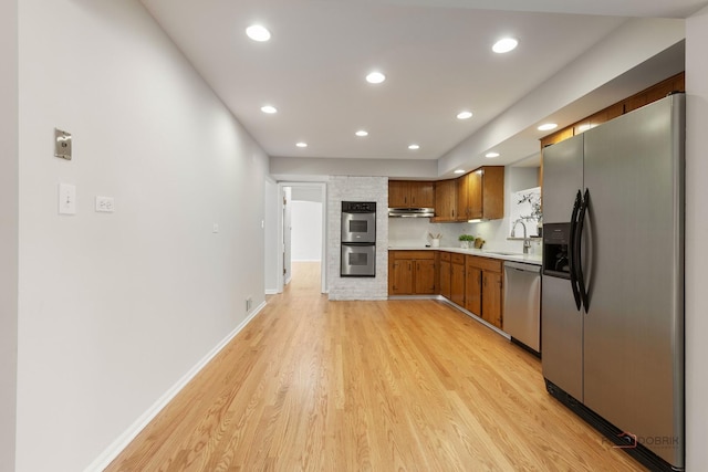 1712 Shawnee Trl, Northbrook, IL 60062 - kitchen with appliances with stainless steel finishes, a sink, light countertops, light wood finished floors, and recessed lighting