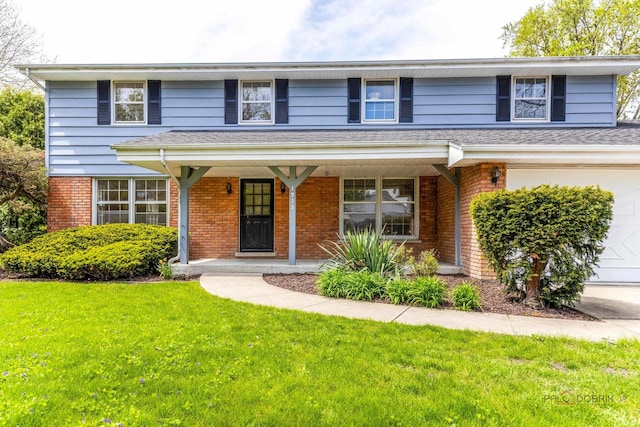 1712 Shawnee Trl, Northbrook, IL 60062 - traditional home with brick siding, a front lawn, and covered porch