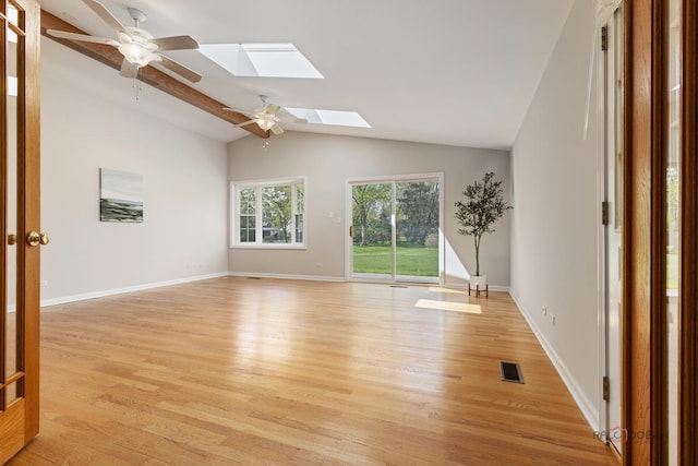 1712 Shawnee Trl, Northbrook, IL 60062 - spare room with a skylight, light wood-style floors, a ceiling fan, vaulted ceiling, and baseboards