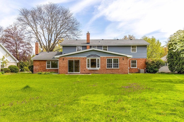 1712 Shawnee Trl, Northbrook, IL 60062 - rear view of property featuring a chimney, brick siding, and a lawn